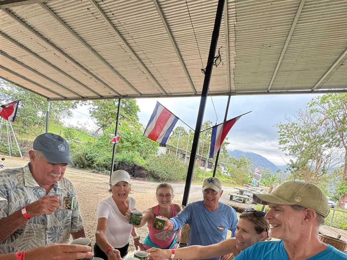 Happy guests toasting with coffee on a Costa Rica tour